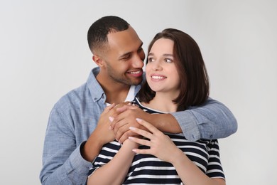 Dating agency. Man hugging his girlfriend indoors