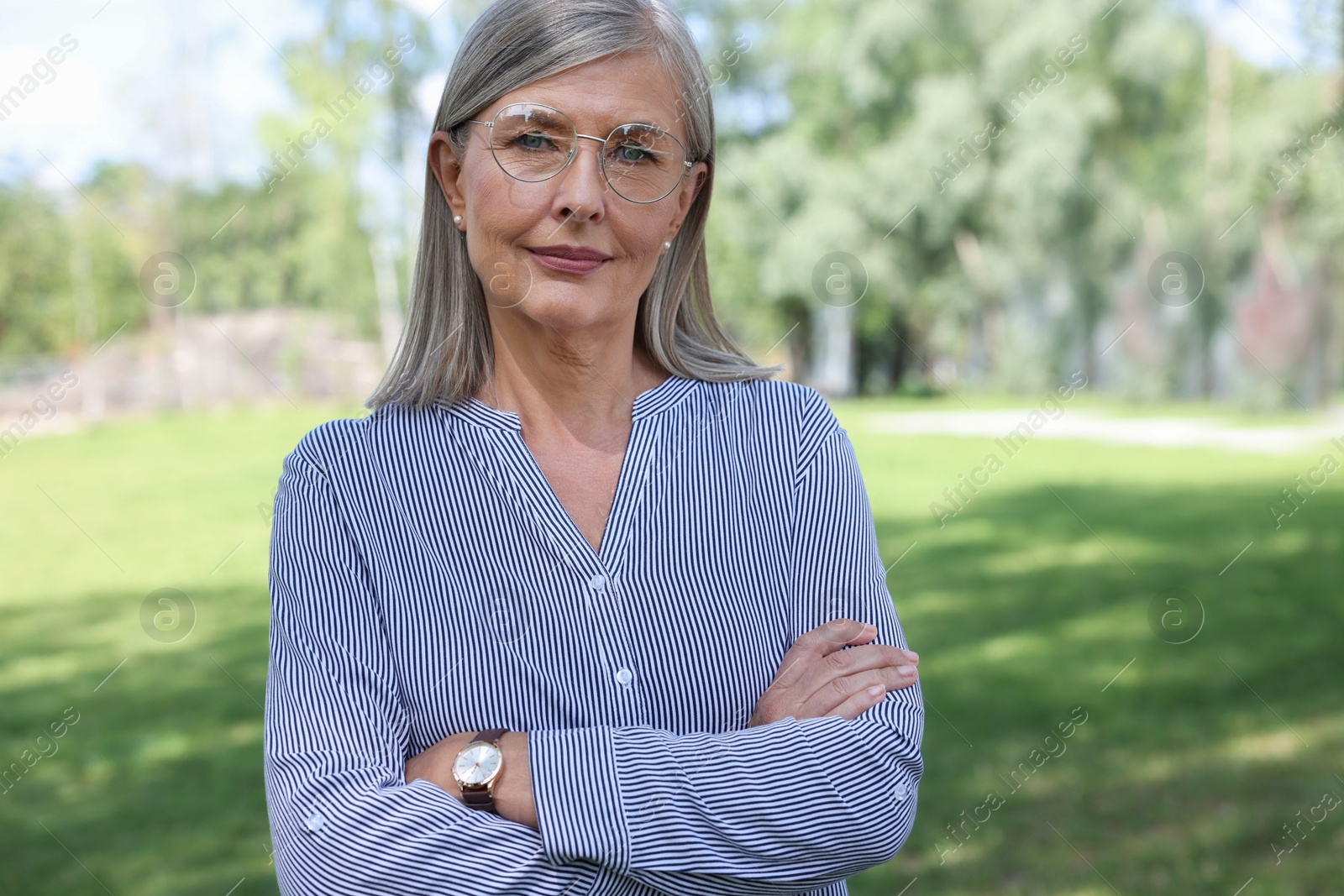 Photo of Portrait of beautiful senior woman in glasses outdoors