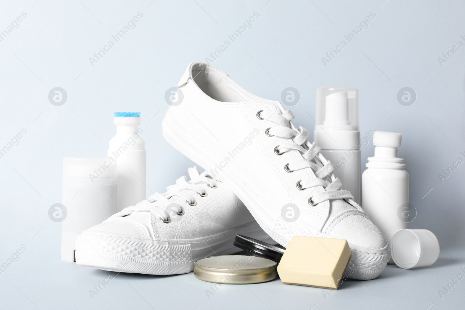 Photo of Composition with stylish footwear and shoe care accessories on white background