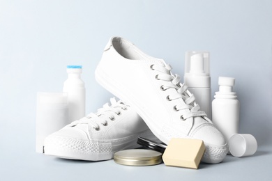 Composition with stylish footwear and shoe care accessories on white background