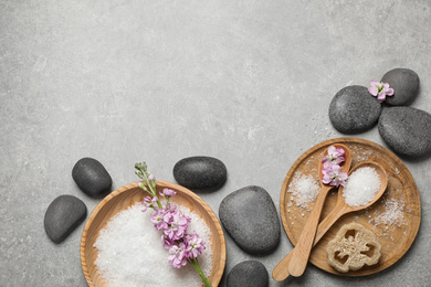 Photo of Flat lay composition with sea salt and spa stones on grey marble table. Space for text