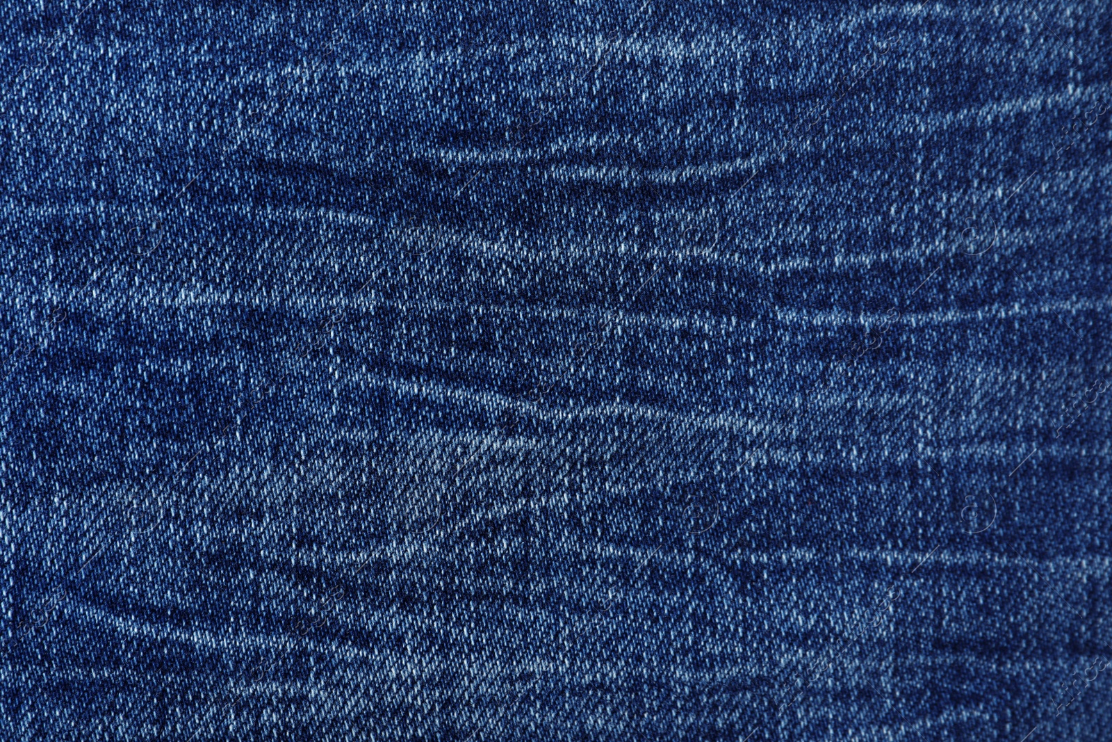 Photo of Texture of dark blue jeans as background, closeup