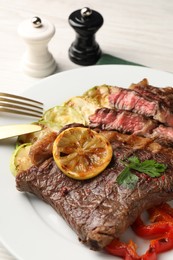 Delicious grilled beef steak and vegetables on plate, closeup