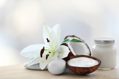 Composition with coconut butter in glass jar and shell on blurred background