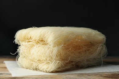 Photo of Block of rice noodles on wooden table, closeup