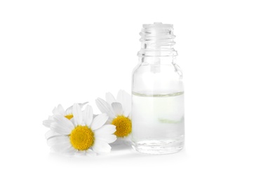 Bottle of herbal essential oil and chamomile flowers isolated on white