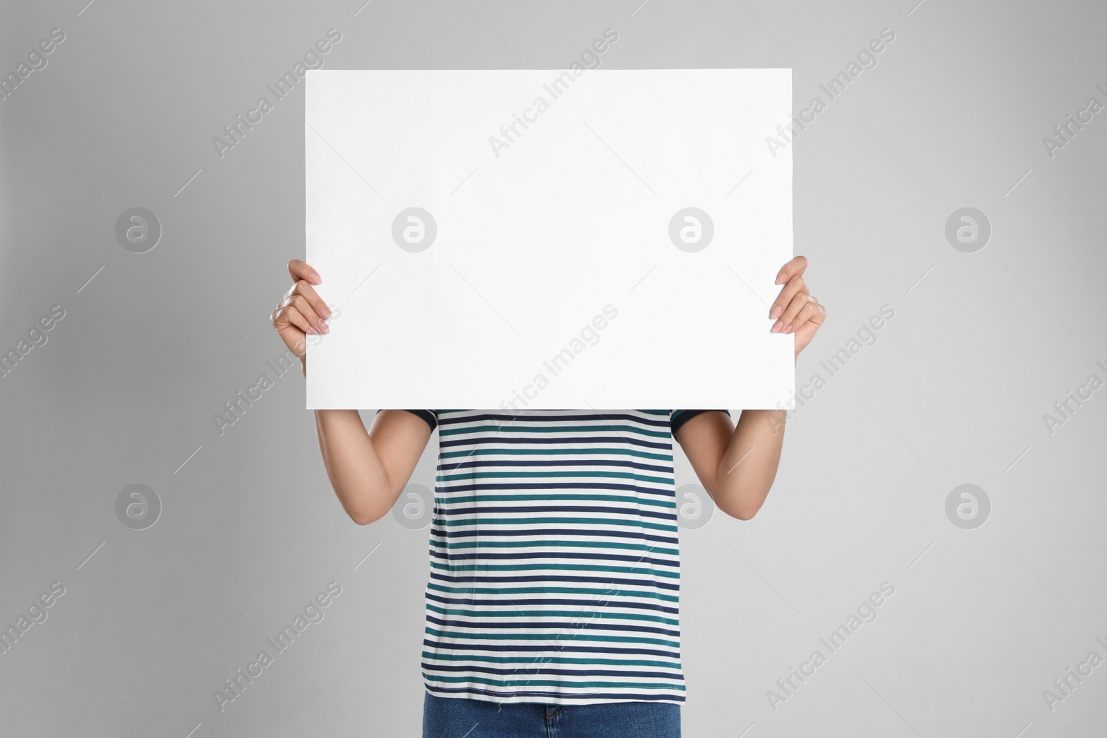 Photo of Woman holding blank poster on light grey background