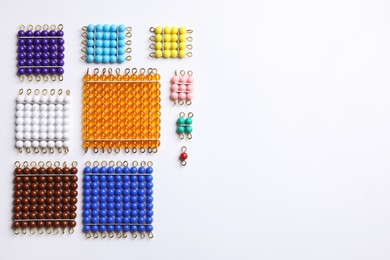 Photo of Set of color bead squares on white background, top view. Montessori toy