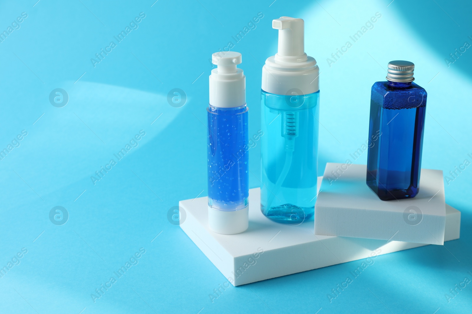 Photo of Set of luxury cosmetic products on light blue background. Space for text