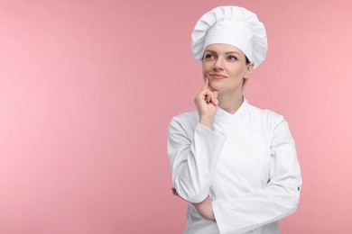 Photo of Woman chef in uniform on pink background, space for text