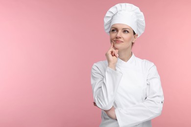 Woman chef in uniform on pink background, space for text