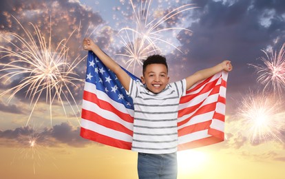 Image of 4th of July - Independence day of America. Happy kid holding national flag of United States against sky with fireworks