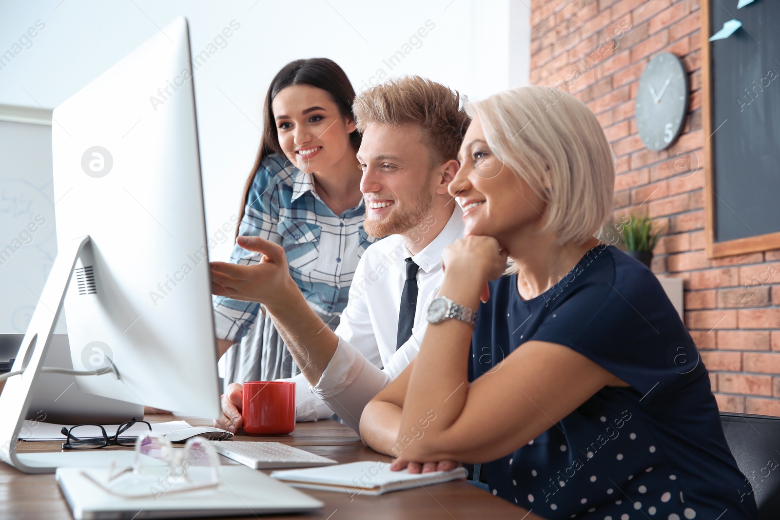 Photo of Business people working on computer at table in office. Professional communication