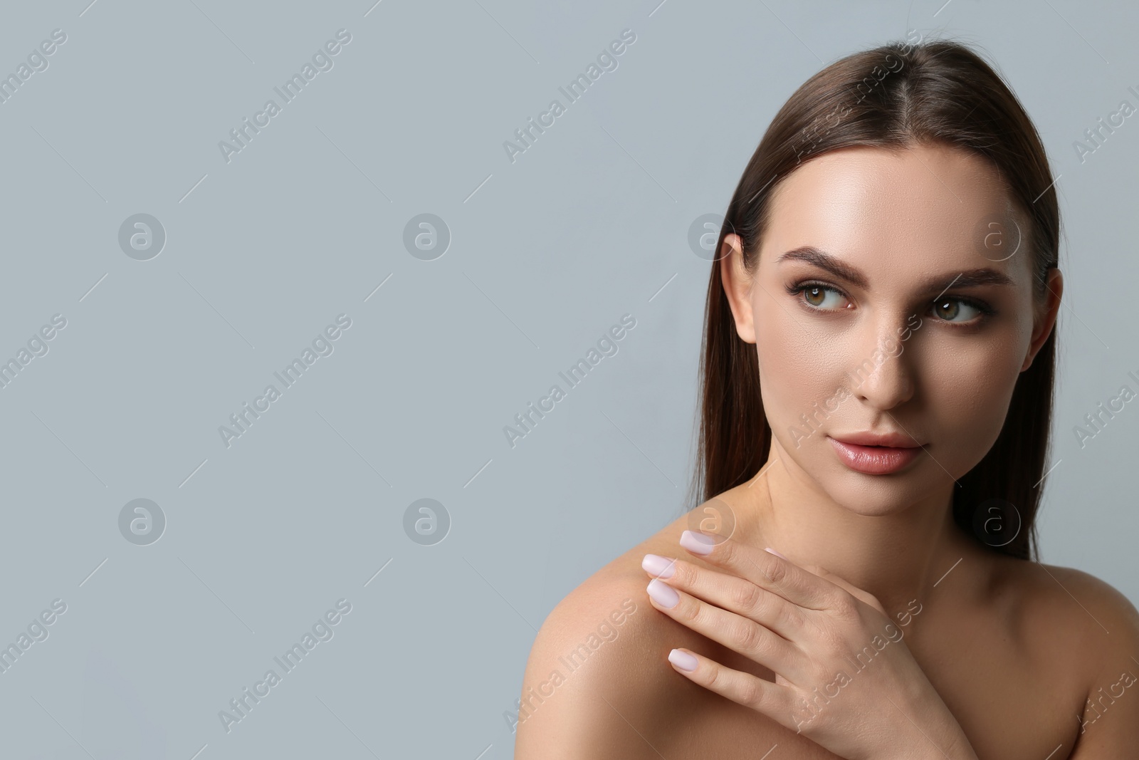 Photo of Portrait of beautiful young woman with plump lips on light grey background. Space for text