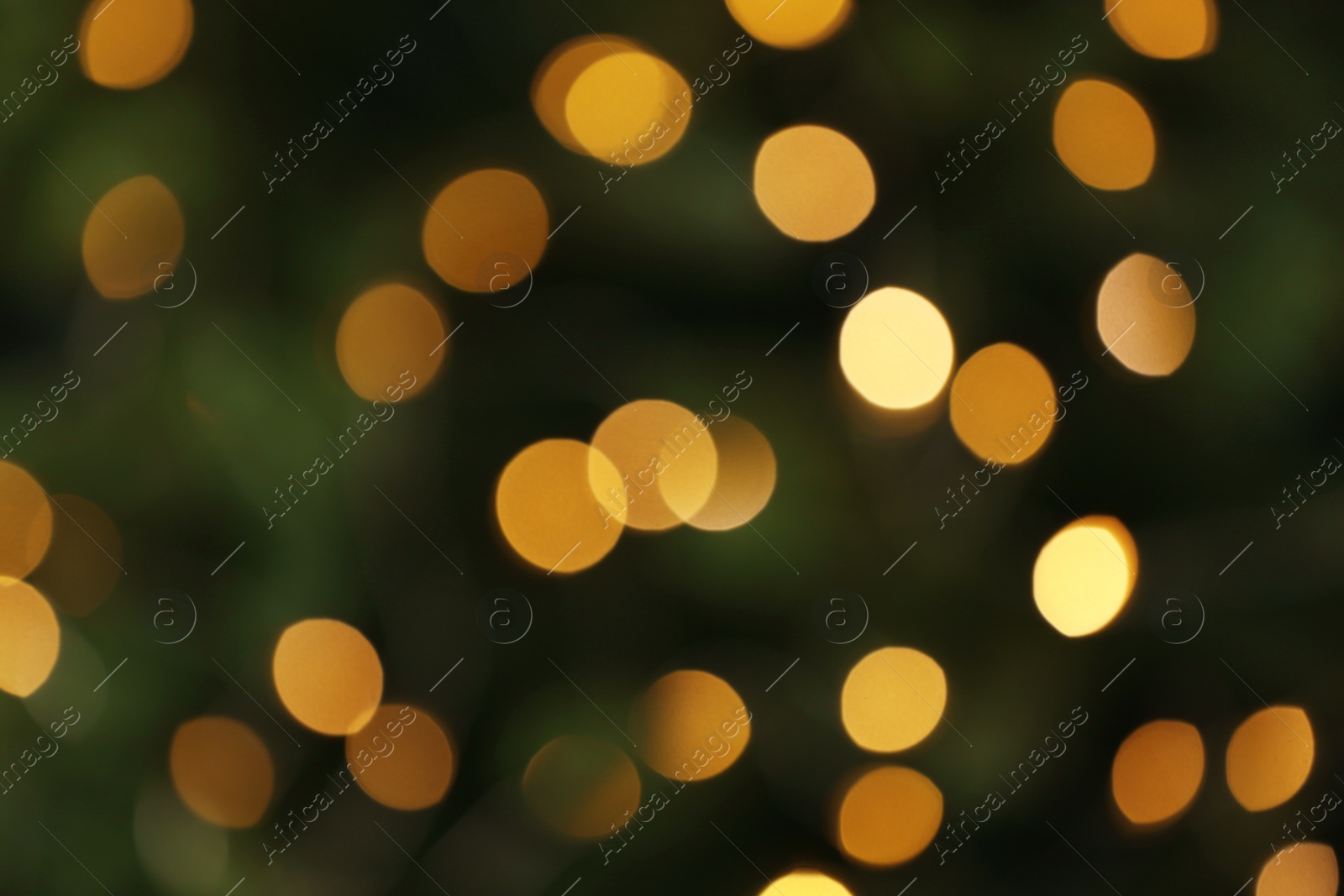 Photo of Abstract background with blurred yellow Christmas lights, bokeh effect