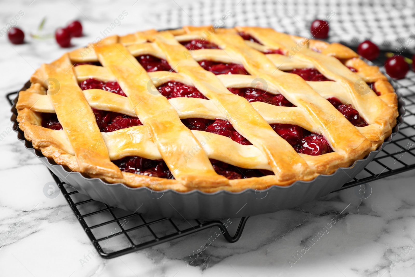 Photo of Delicious fresh cherry pie on white marble table, closeup