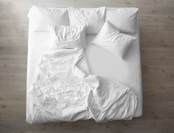 Photo of Comfortable bed with soft pillows indoors, top view