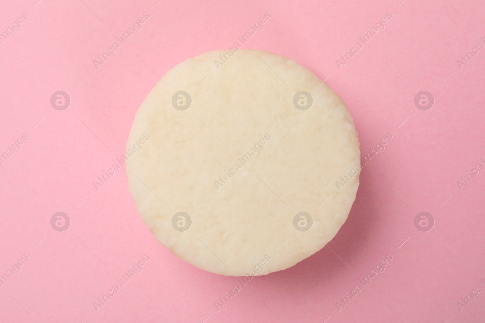 Photo of Solid shampoo bar on pink background, top view. Hair care