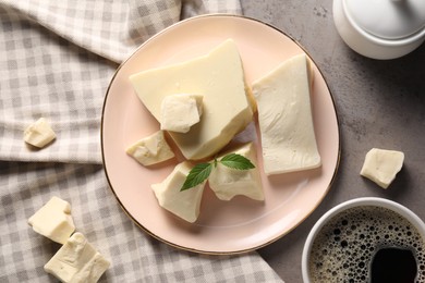 Photo of Pieces of tasty white chocolate, mint and coffee on grey table, flat lay