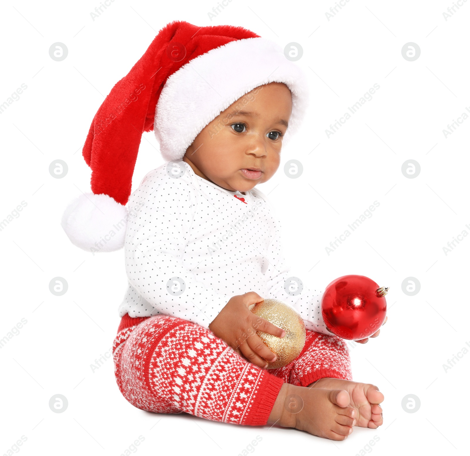 Photo of Festively dressed African-American baby with Christmas decorations on white background