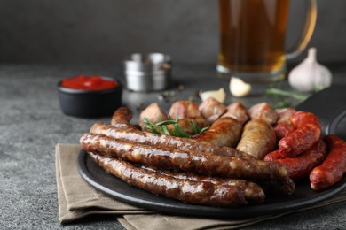 Set of different tasty snacks on dark grey table, closeup view