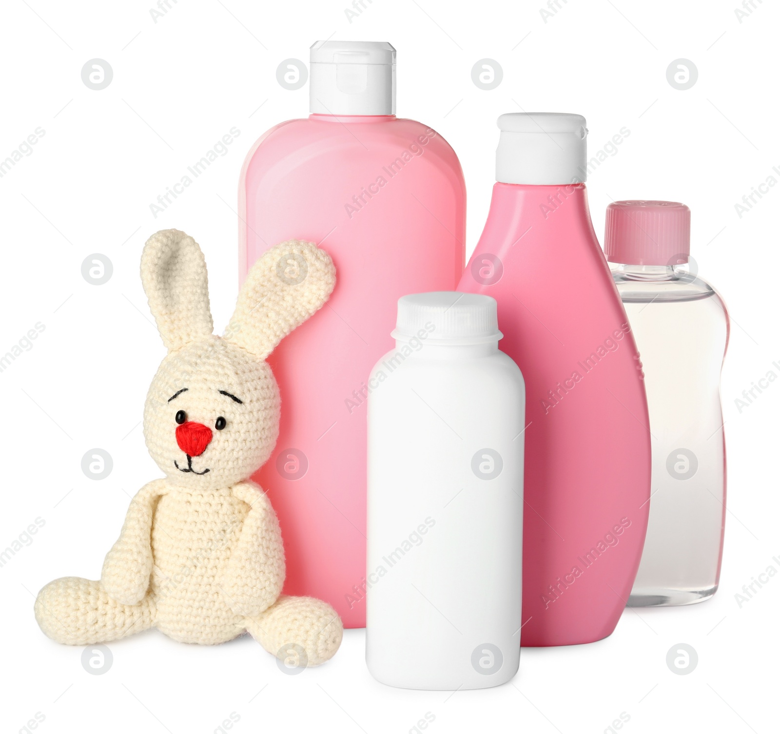 Photo of Bottles of baby cosmetic products and toy bunny on white background