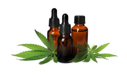 Photo of CBD oil, THC tincture and hemp leaves on white background