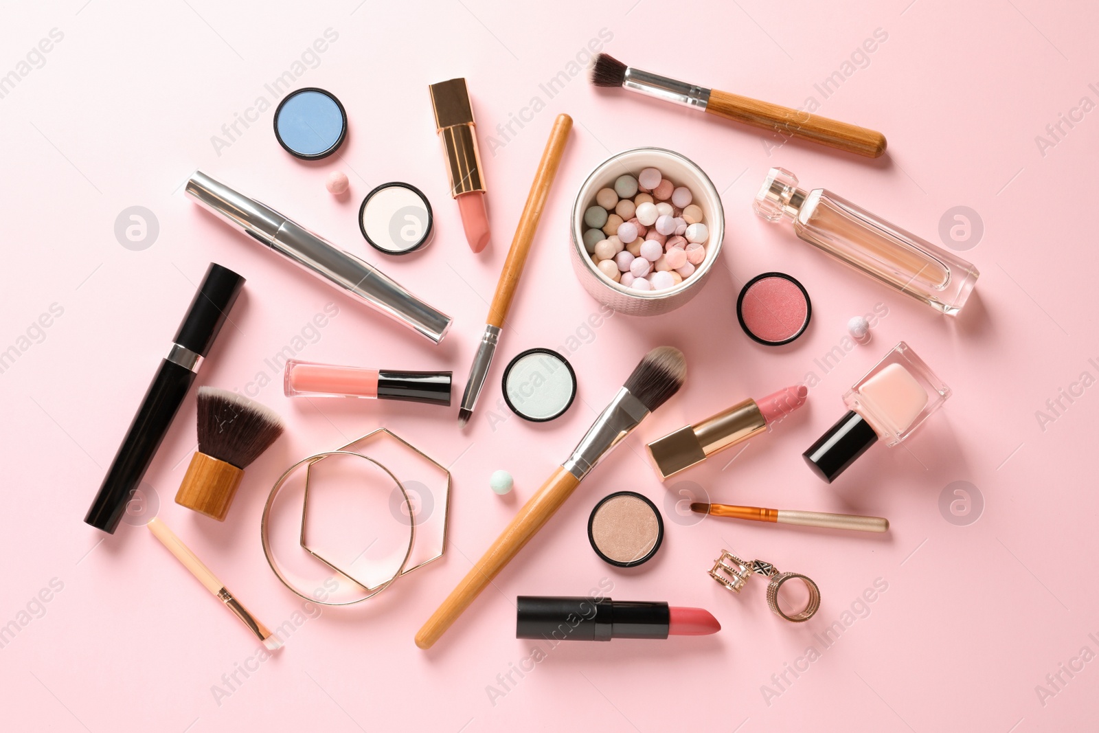 Photo of Flat lay composition with products for decorative makeup on pastel pink background