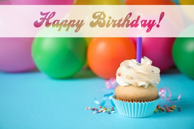Image of Happy Birthday! Delicious cupcake with candle on blue table