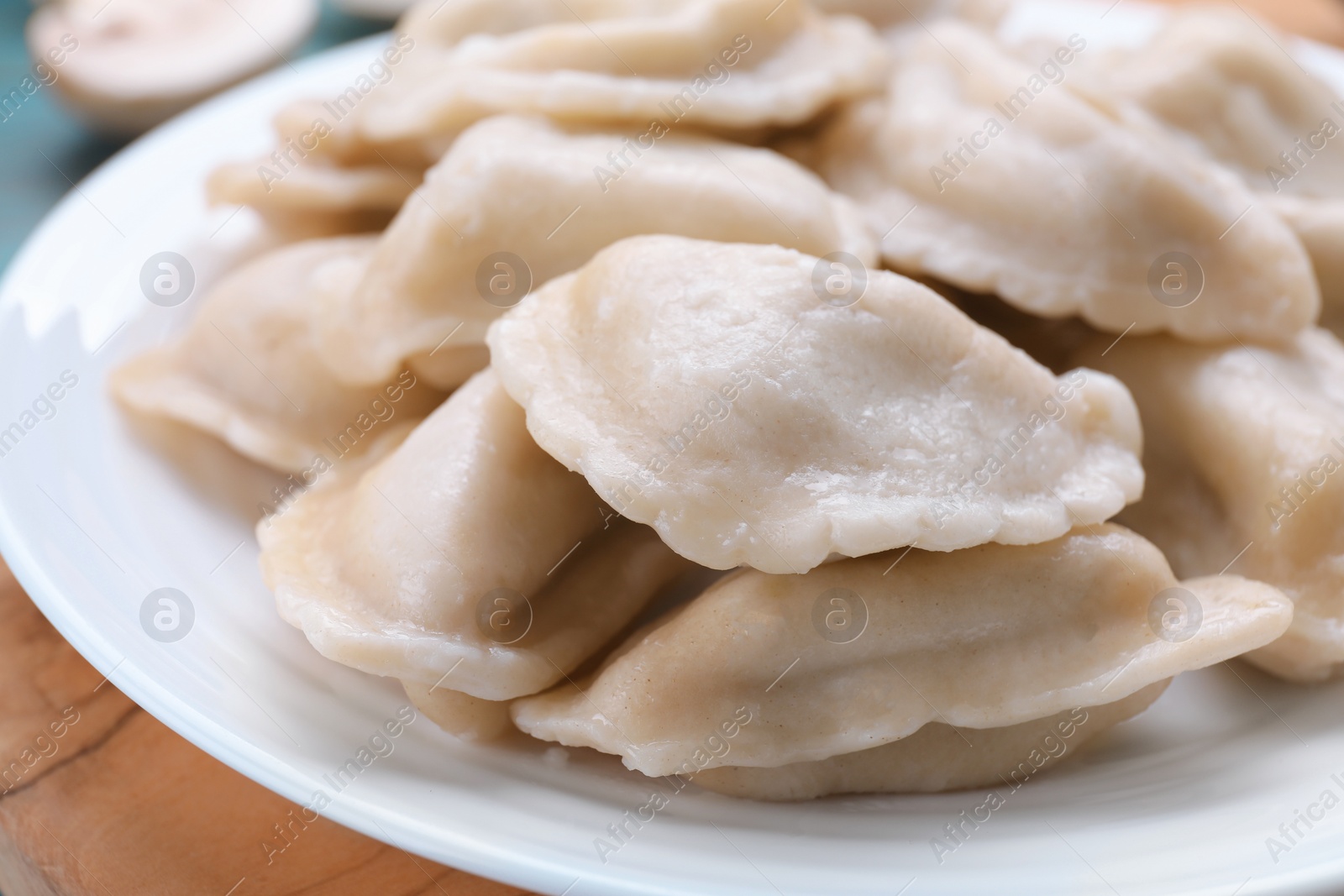 Photo of Delicious dumplings (varenyky) with potatoes on plate, closeup