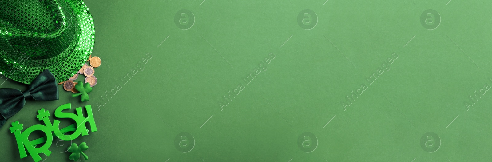 Photo of Leprechaun's hat and St. Patrick's day decor on green background, flat lay. Space for text