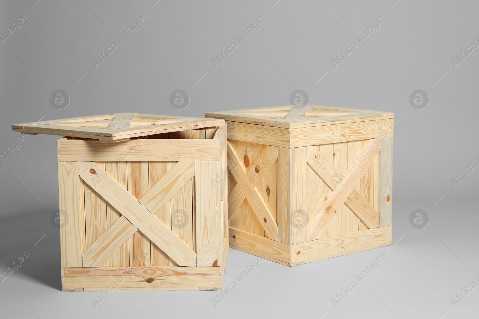 Photo of Pair of wooden crates on grey background