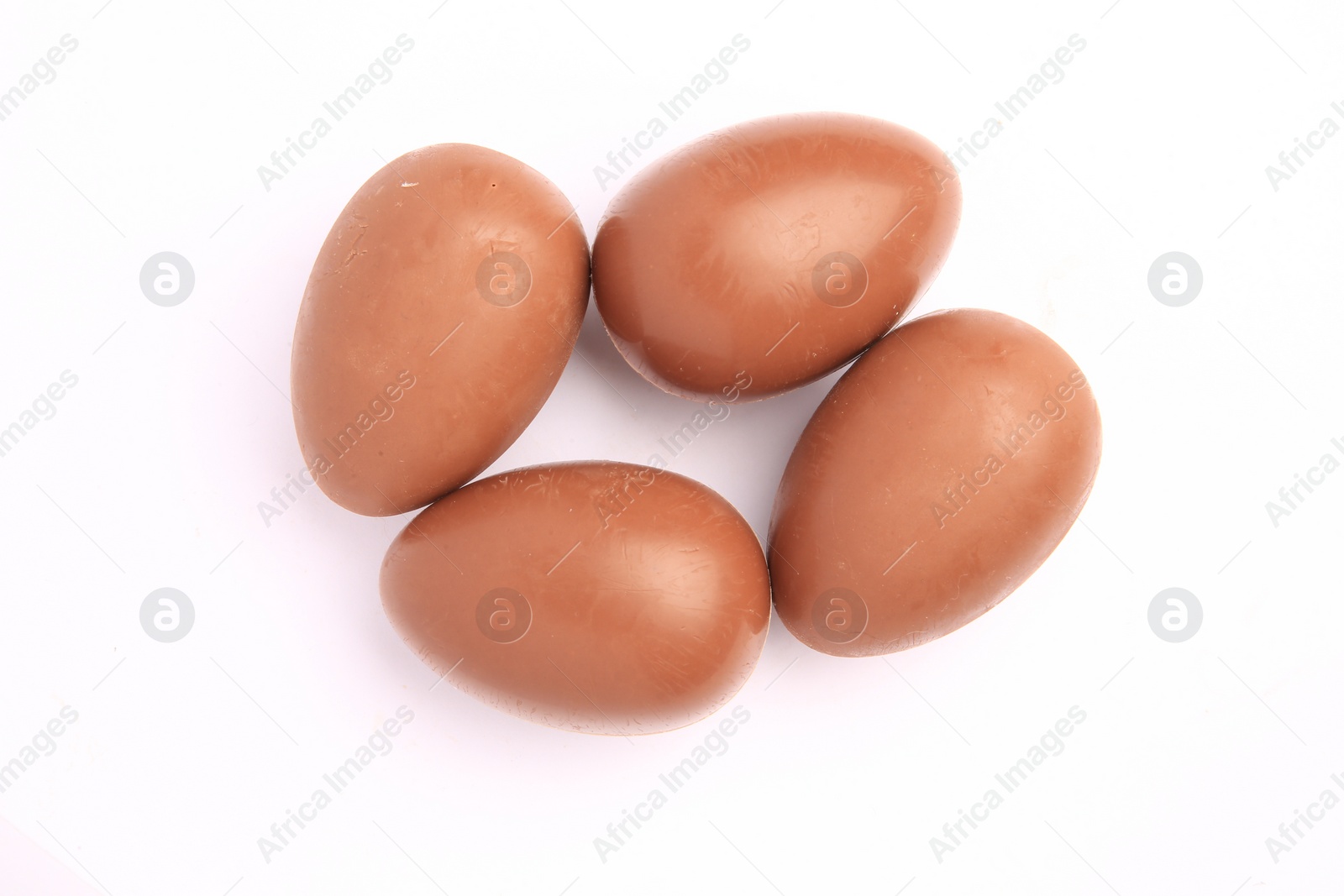 Photo of Sveti Vlas, Bulgaria - June 27, 2023: Unwrapped Kinder Surprise Eggs isolated on white, top view