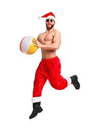 Muscular young man in Santa hat with ball jumping on white background