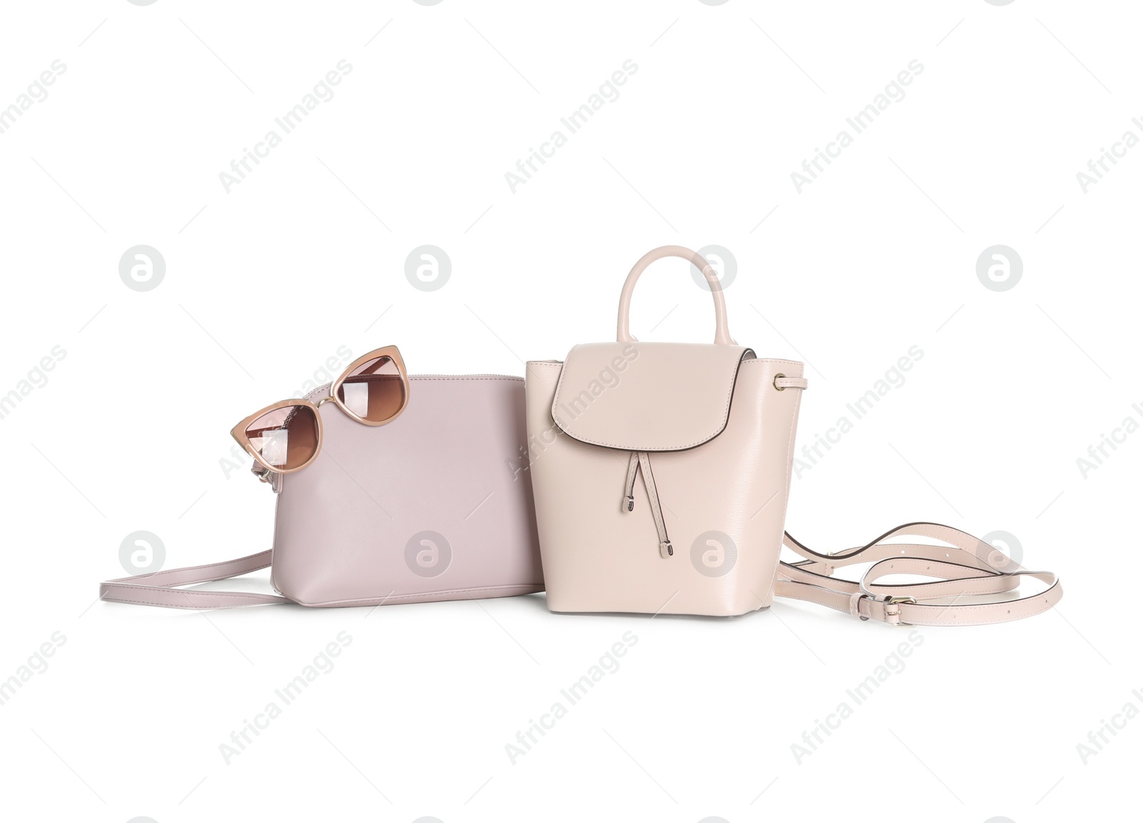 Photo of Different stylish woman's bags and sunglasses isolated on white