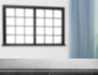 Image of Empty grey stone surface and blurred view of modern window 