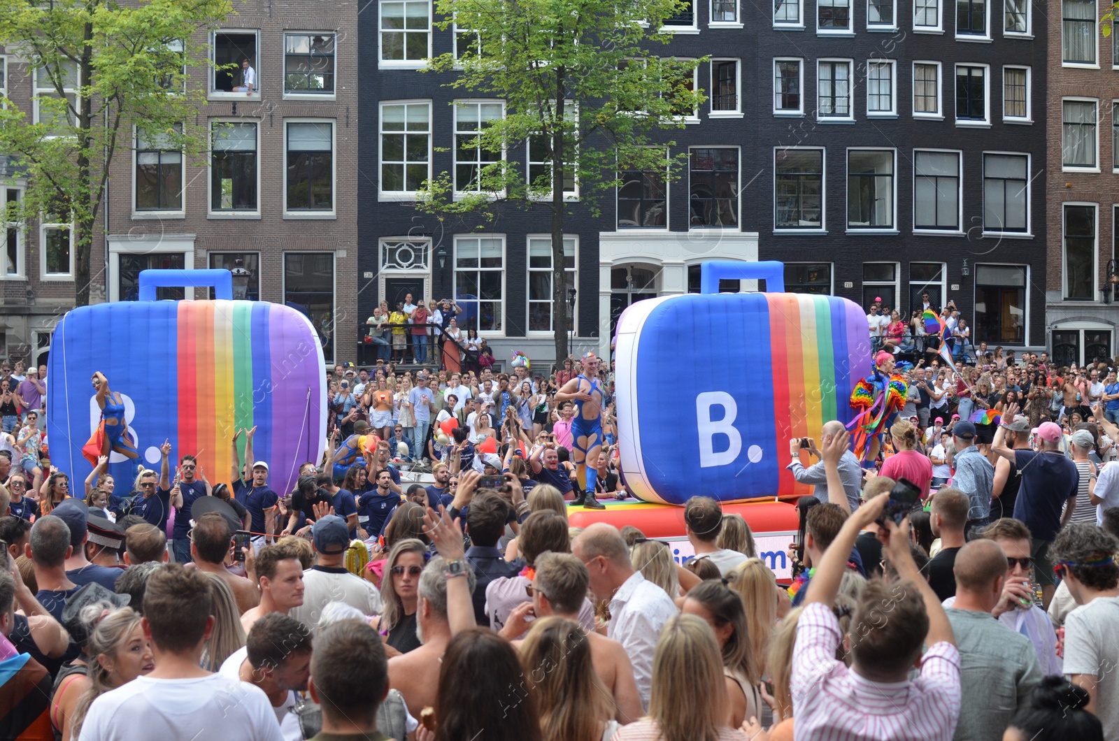 Photo of AMSTERDAM, NETHERLANDS - AUGUST 06, 2022: Many people at LGBT pride parade on summer day