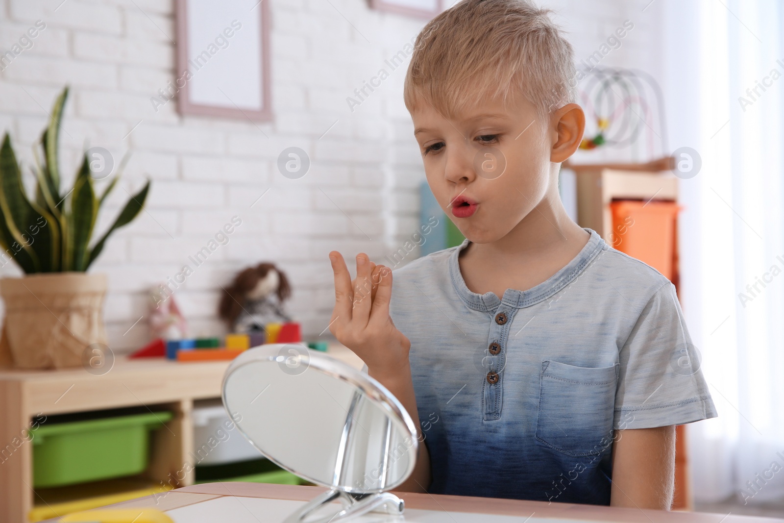 Photo of Cute little boy at speech therapist office