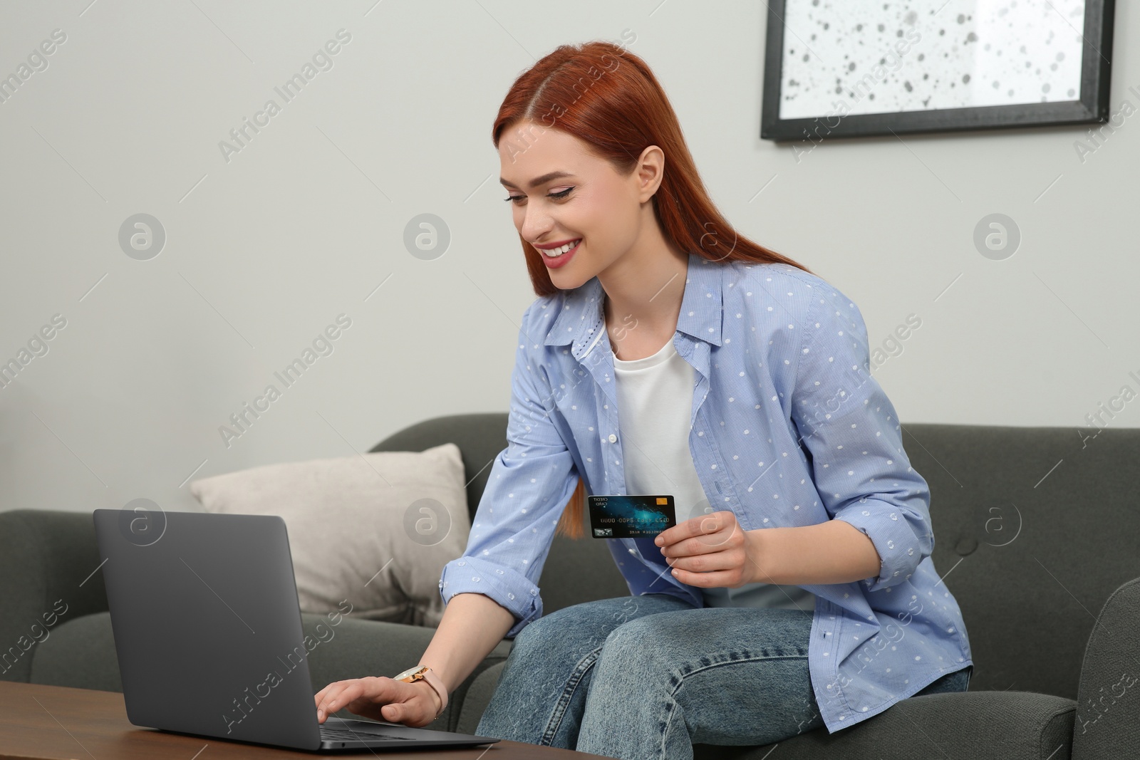 Photo of Happy woman with credit card using laptop for online shopping at home. Space for text