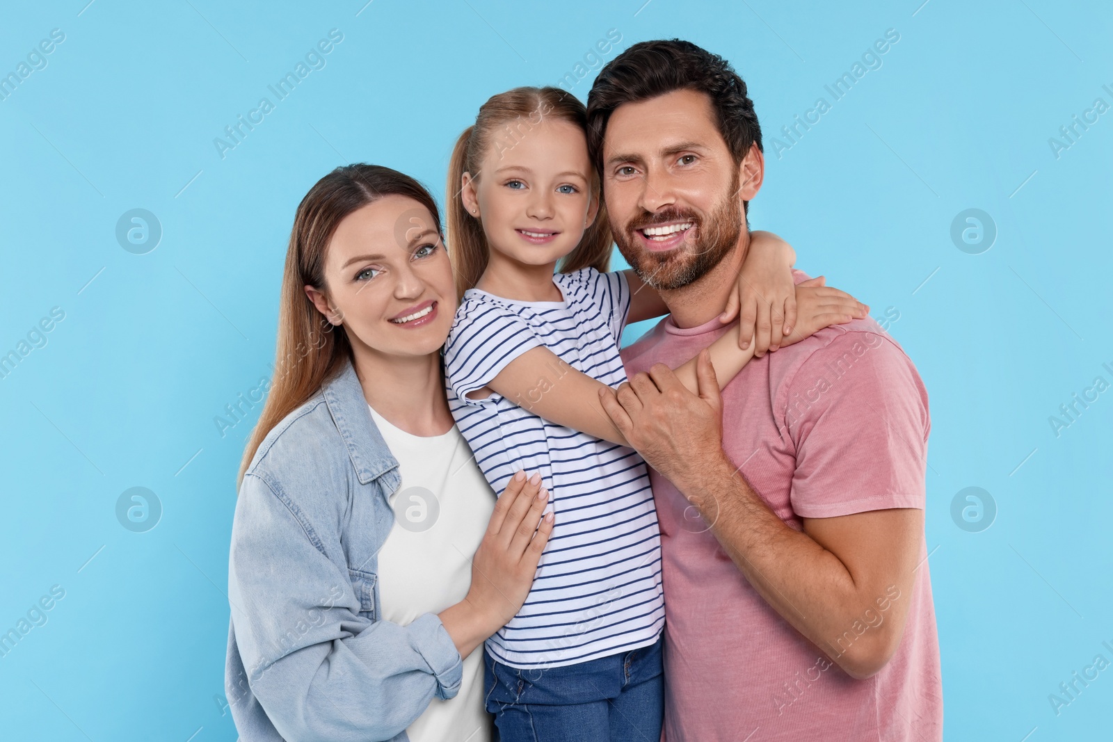 Photo of Happy family together on light blue background