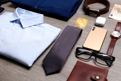 Photo of Composition with clothes and accessories on wooden background. Packing for business trip