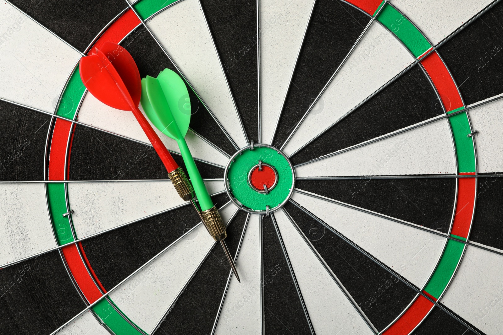 Photo of Red and green arrows on dart board, top view