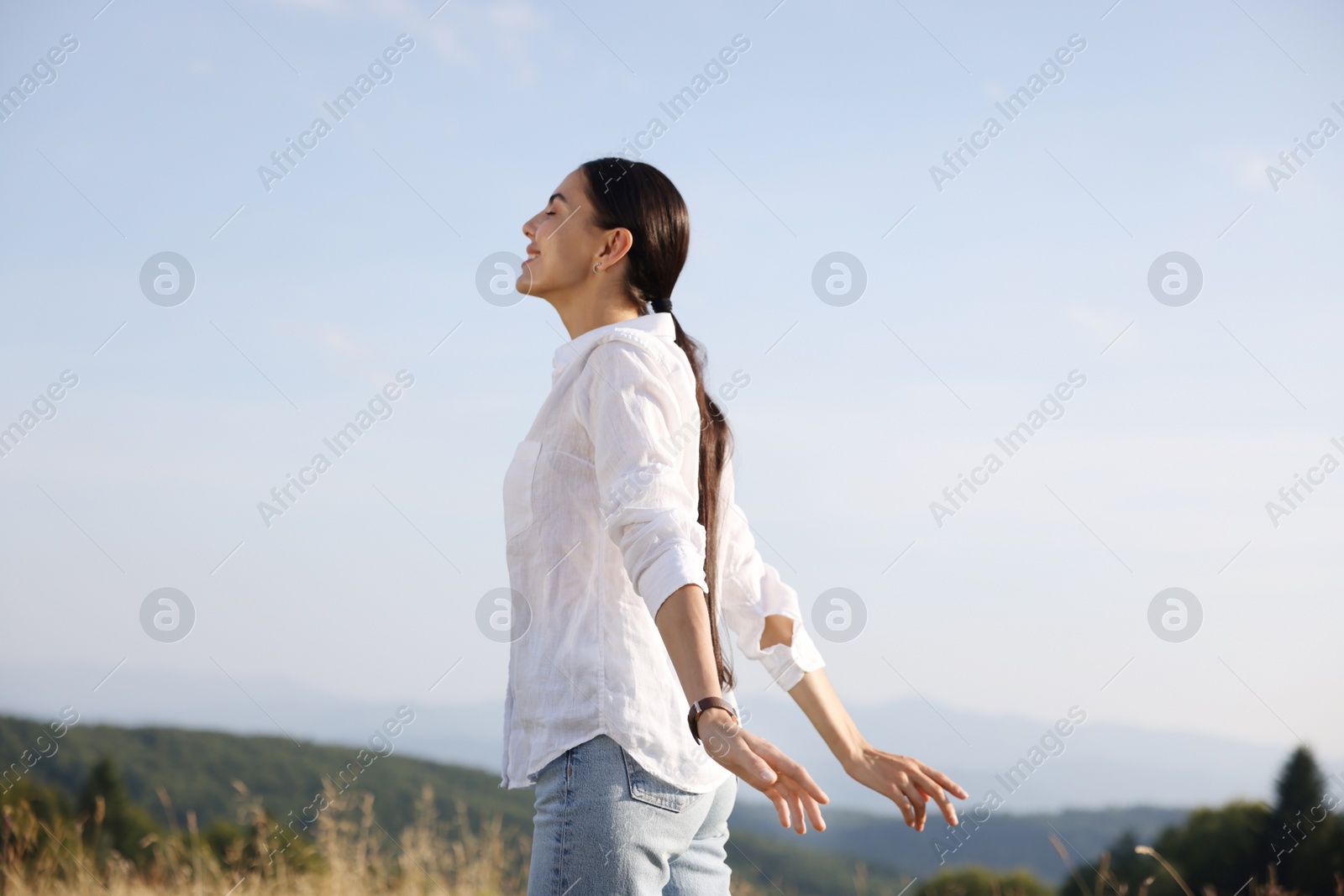 Photo of Feeling freedom. Happy woman enjoying nature outdoors