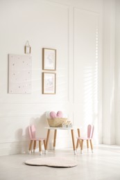 Photo of Baby room interior with stylish furniture and toys