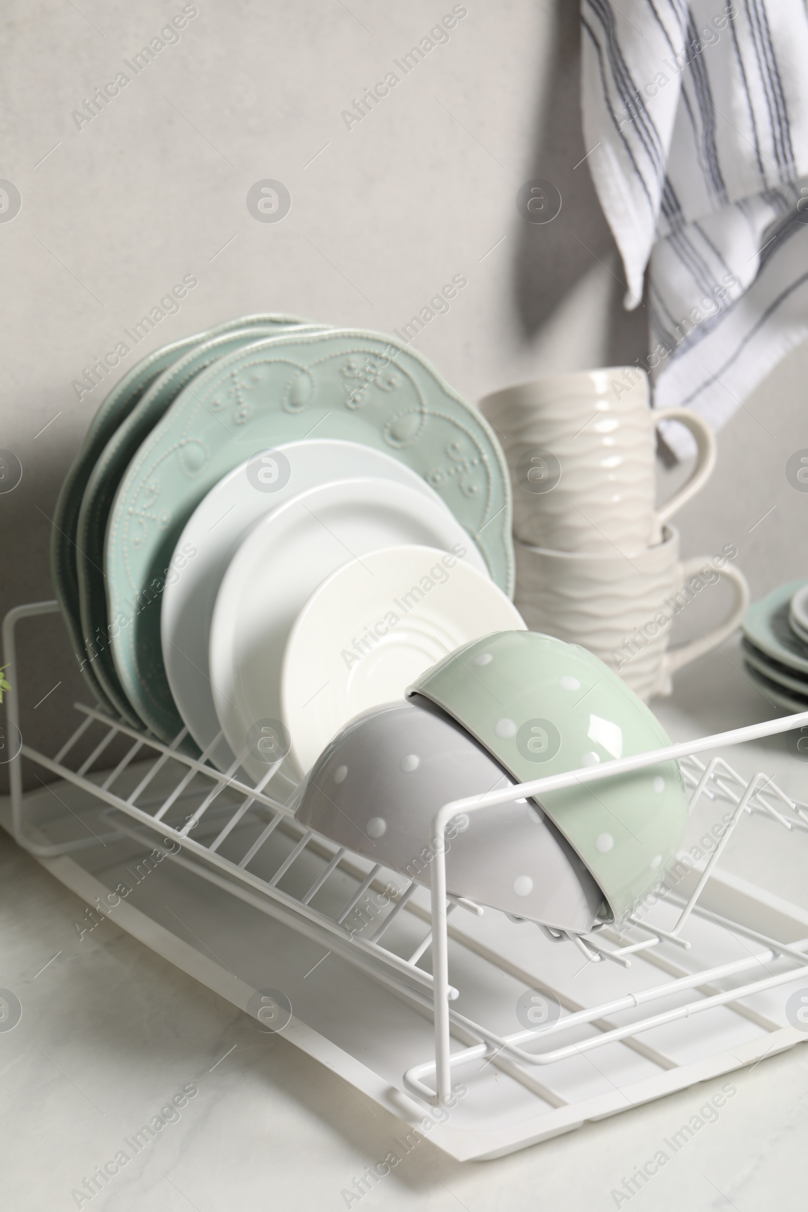 Photo of Many different clean dishware and cups on white table indoors