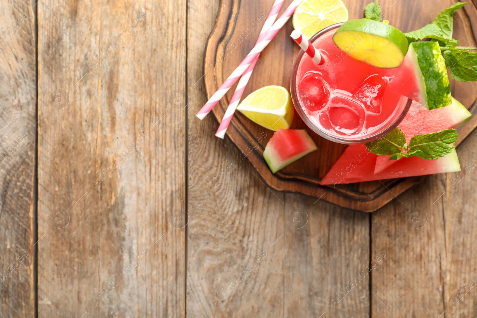 Photo of Delicious fresh watermelon drink on wooden table, top view. Space for text