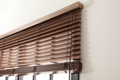 Photo of Modern window with stylish wooden blinds indoors