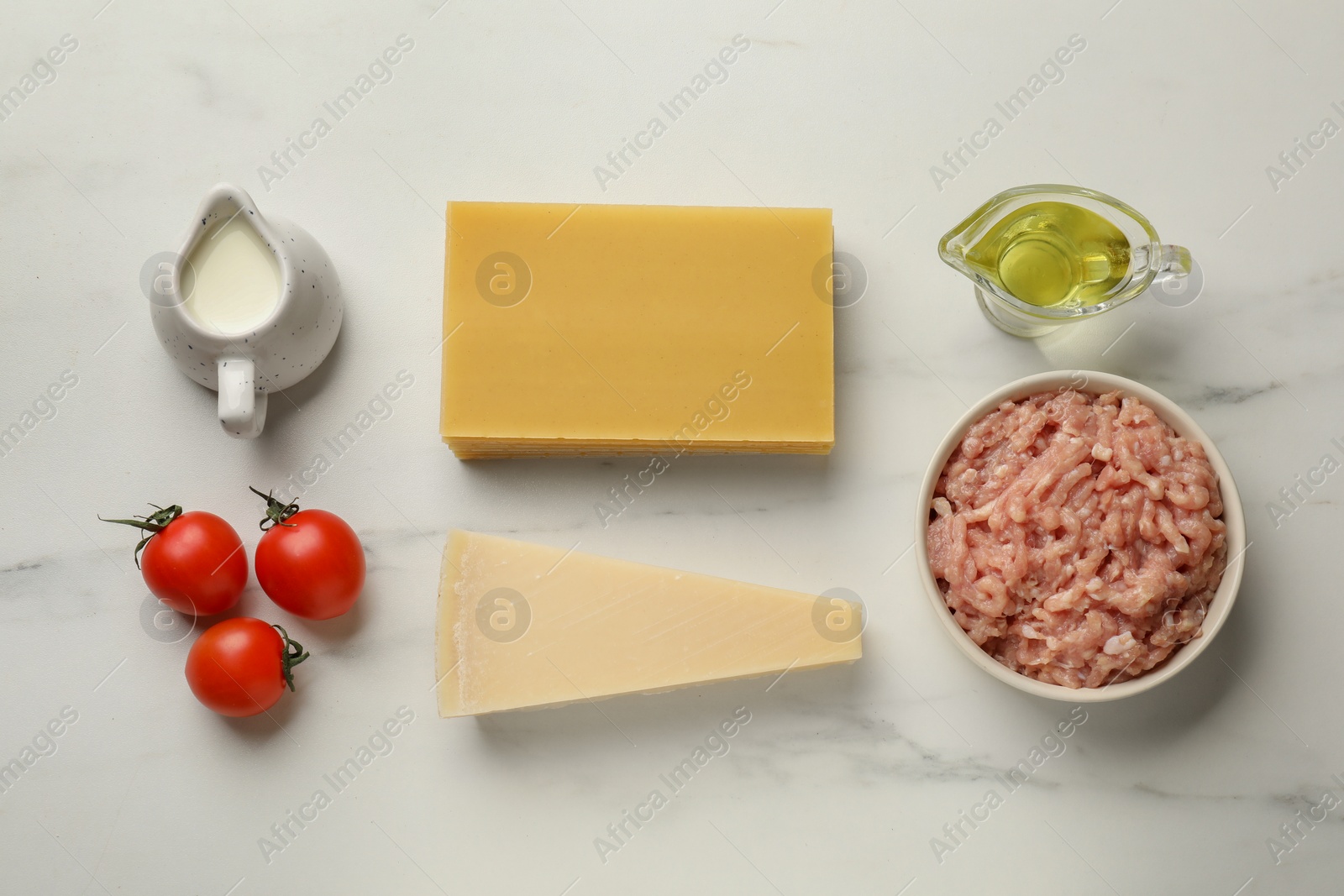 Photo of Ingredients for lasagna on white marble table, flat lay