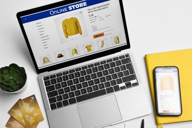 Photo of Online shopping. Composition with laptop on white background, above view