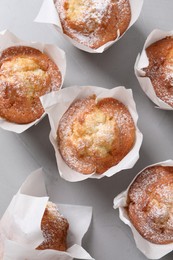 Photo of Delicious muffins on grey table, flat lay